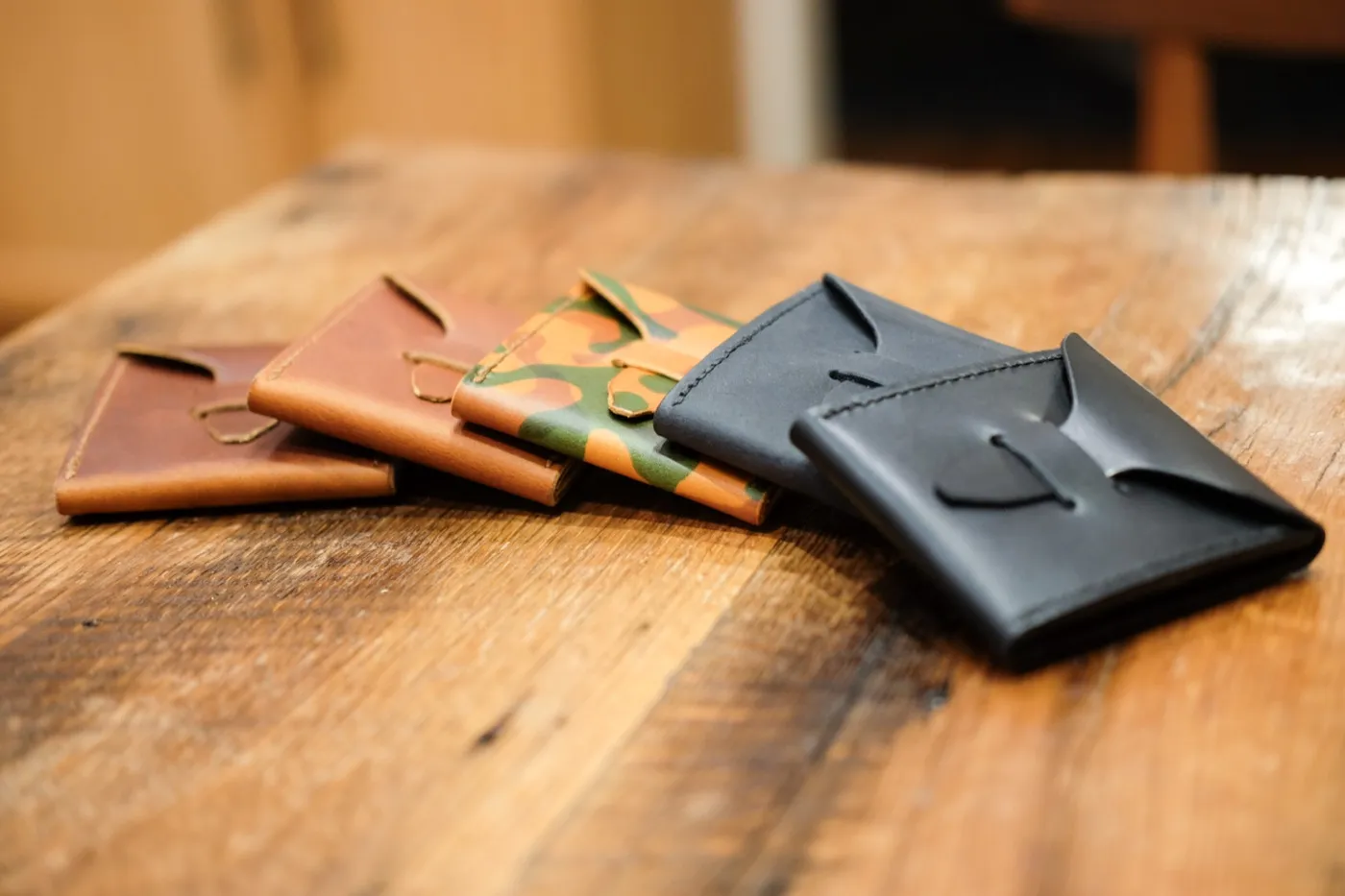Four pick cases fanned out on a wooden table
