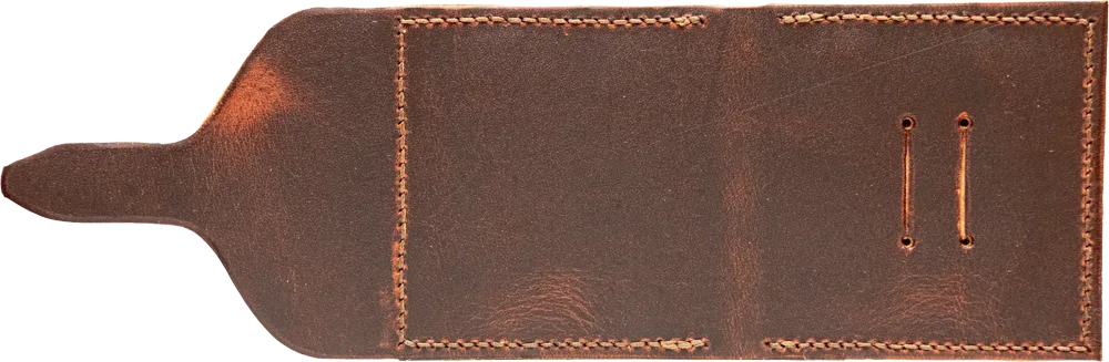 The outside, open flat. Visible grain and wax variation, raised saddle stitches at the edges.