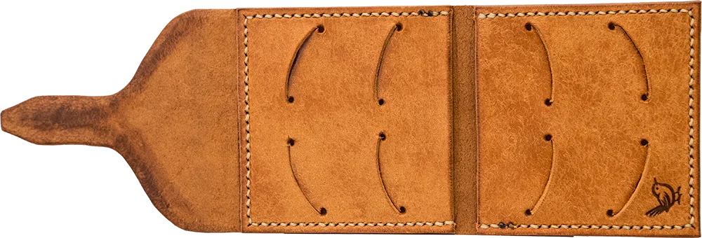 Open flat, eight pick slots cut into the same textured tan leather, with the wren mark stamped in one corner.