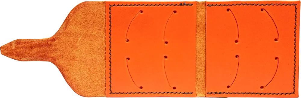 Open flat, eight pick slots on a smooth blaze orange interior, with a suede tongue.